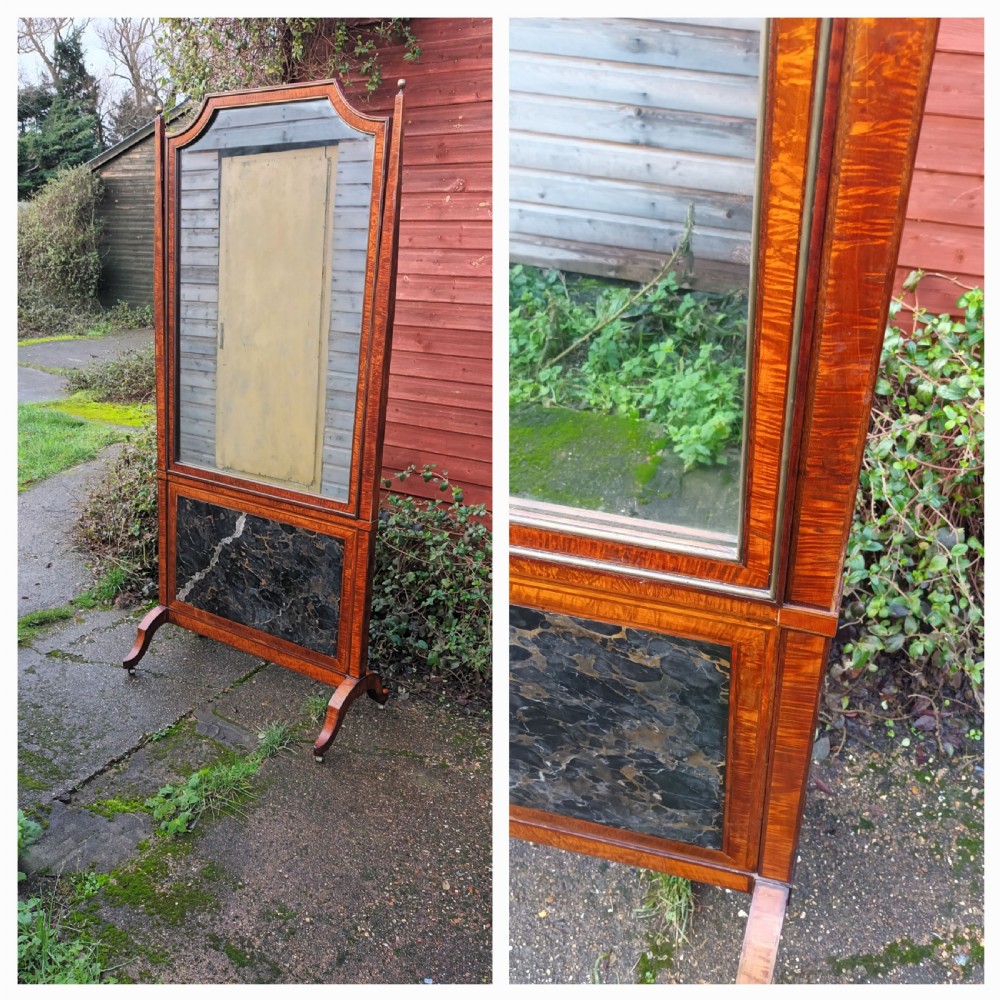 An early nineteenth-century timber cheval mirror featuring a shaped crest, slender side posts with finials, and a fold-down lower marble panel resting on splayed feet. View XV