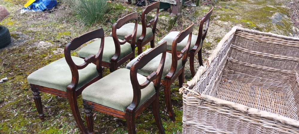 A set of six dark mahogany Regency dining chairs featuring scroll-carved open backs and green velvet upholstered seats. View XII