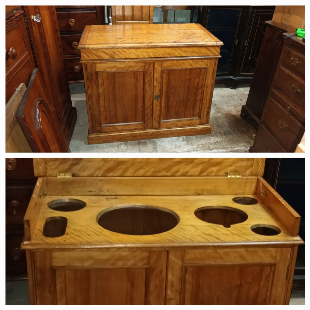 A Victorian satin birch washstand cabinet with a hinged lid raised to show circular cutouts above two panelled doors. View III
