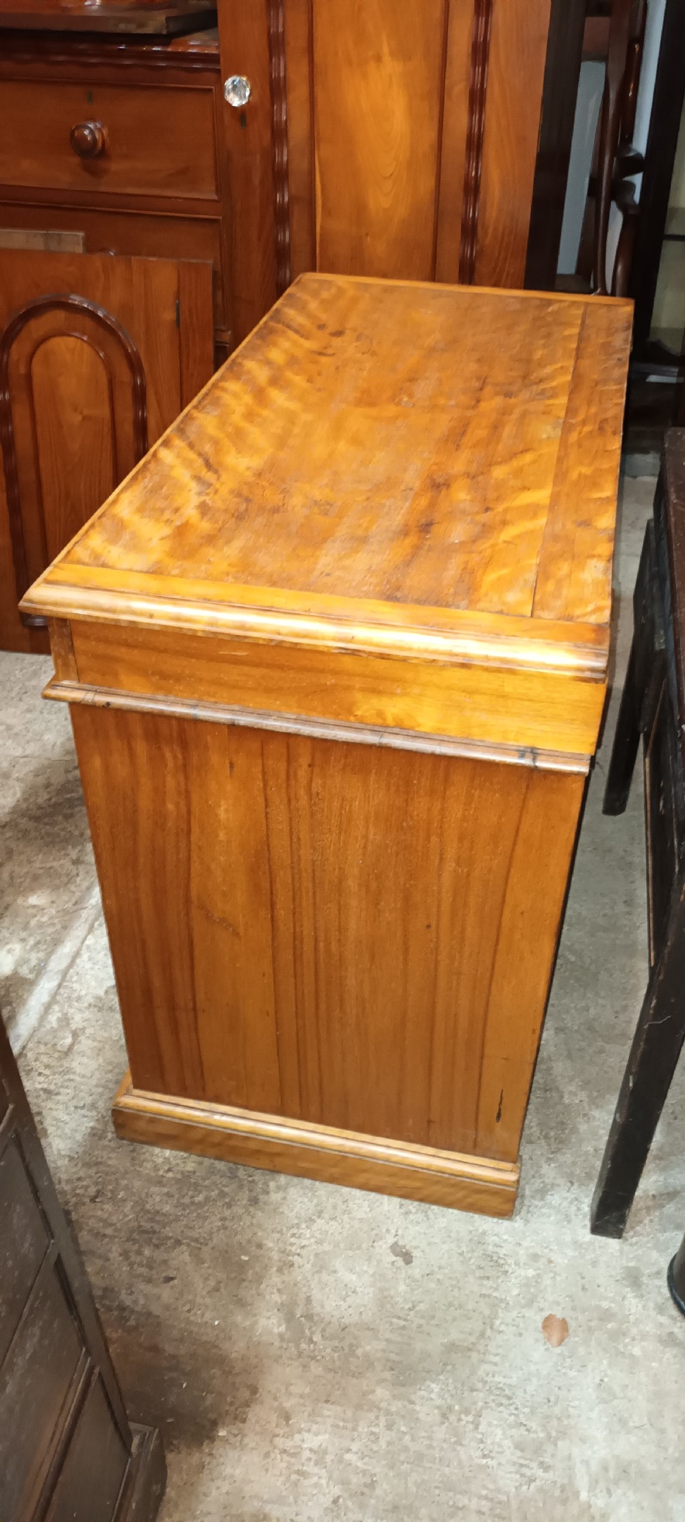 A Victorian satin birch washstand cabinet with a hinged lid raised to show circular cutouts above two panelled doors. View XII