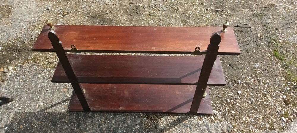Mahogany and brass wall shelves.  View V