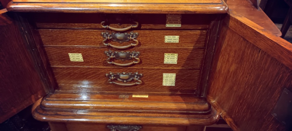 Late Victorian oak fitted cutlery cabinet with some cutlery. By Walker & Hall. View VI