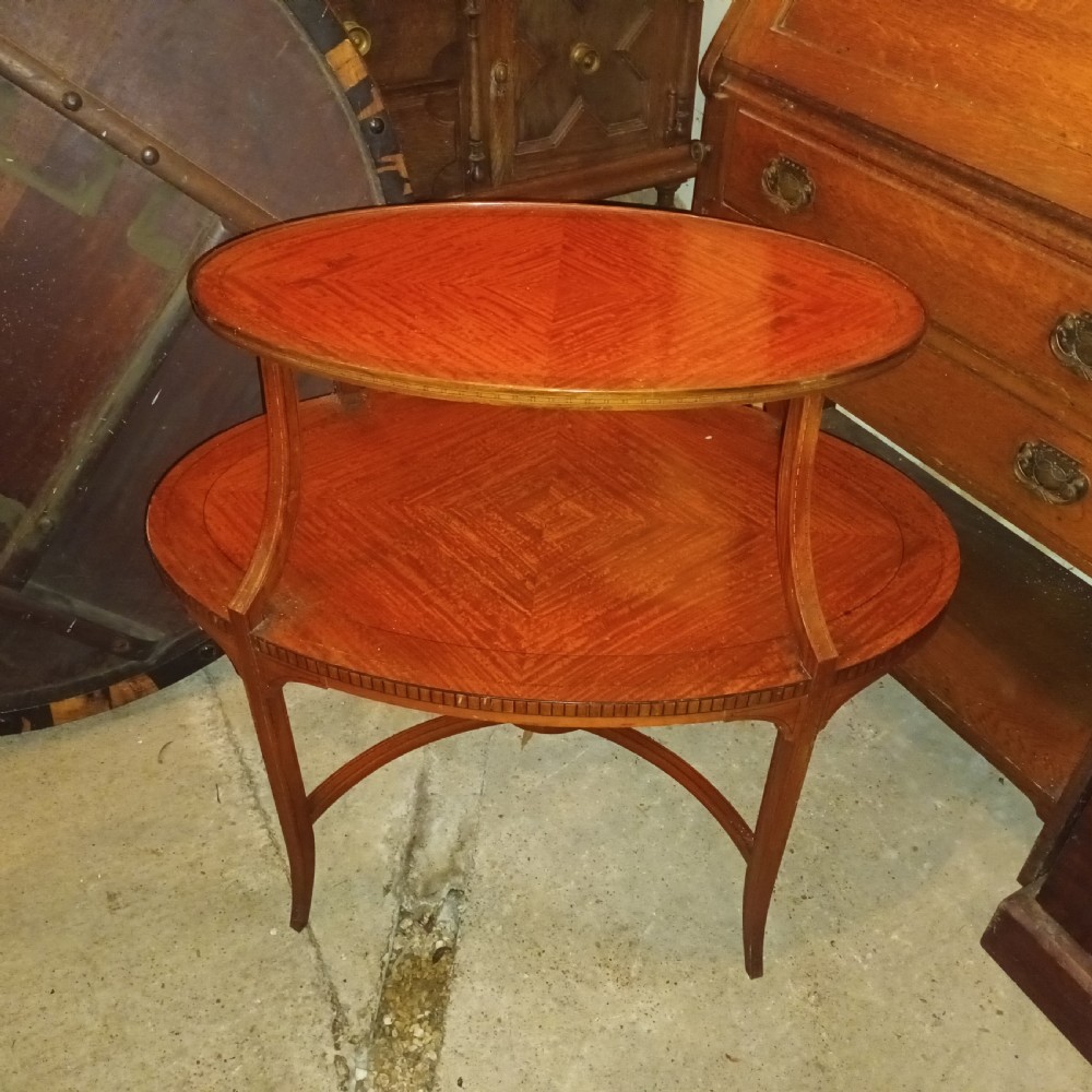 An Edwardian oval two-tier satinwood etagere side table with diamond-matched wood veneer and swept legs. View II