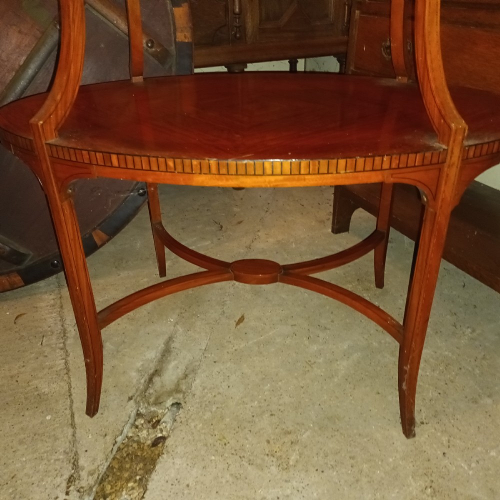An Edwardian oval two-tier satinwood etagere side table with diamond-matched wood veneer and swept legs. View III