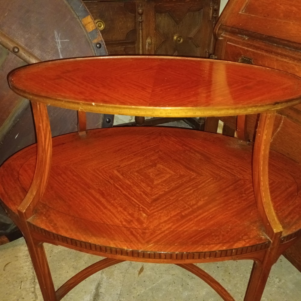 An Edwardian oval two-tier satinwood etagere side table with diamond-matched wood veneer and swept legs. View VII