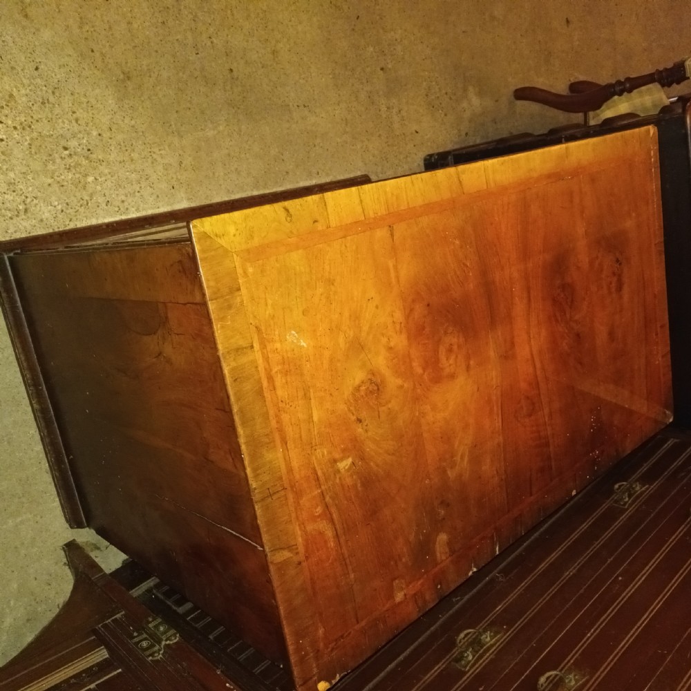An early eighteenth-century figured walnut chest of drawers featuring two short over three long drawers with decorative brass plate handles. View XIII