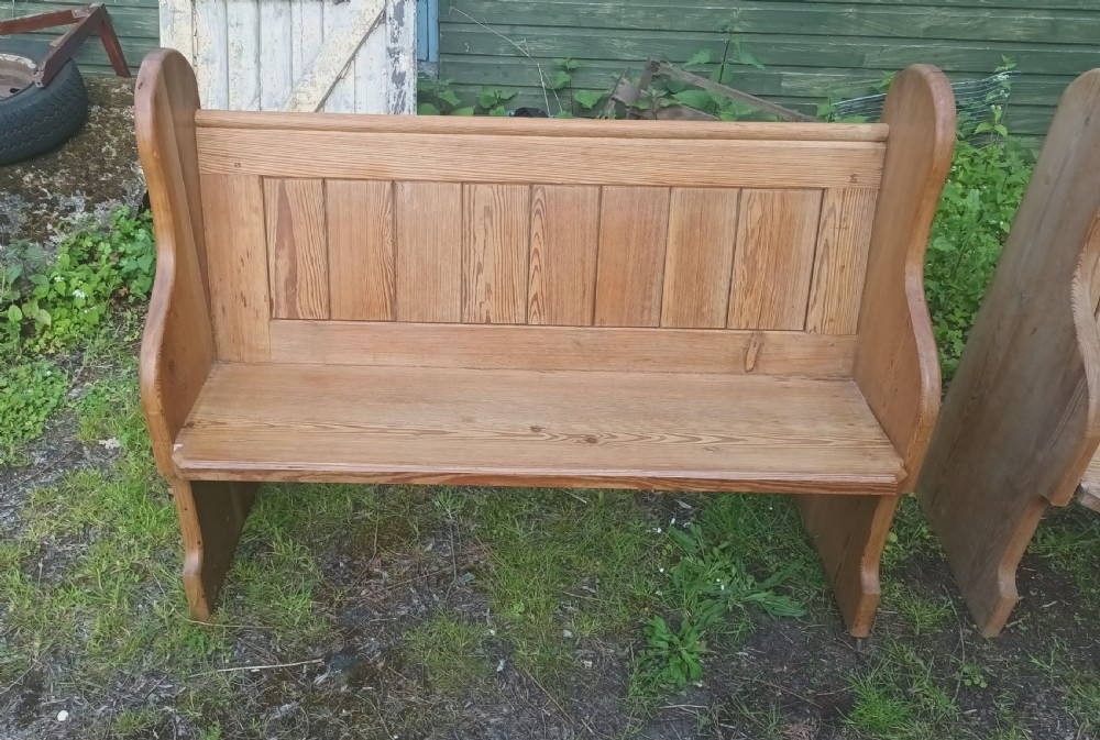 Pair of late Victorian pitch pine kitchen pews with loose cushions.  View II