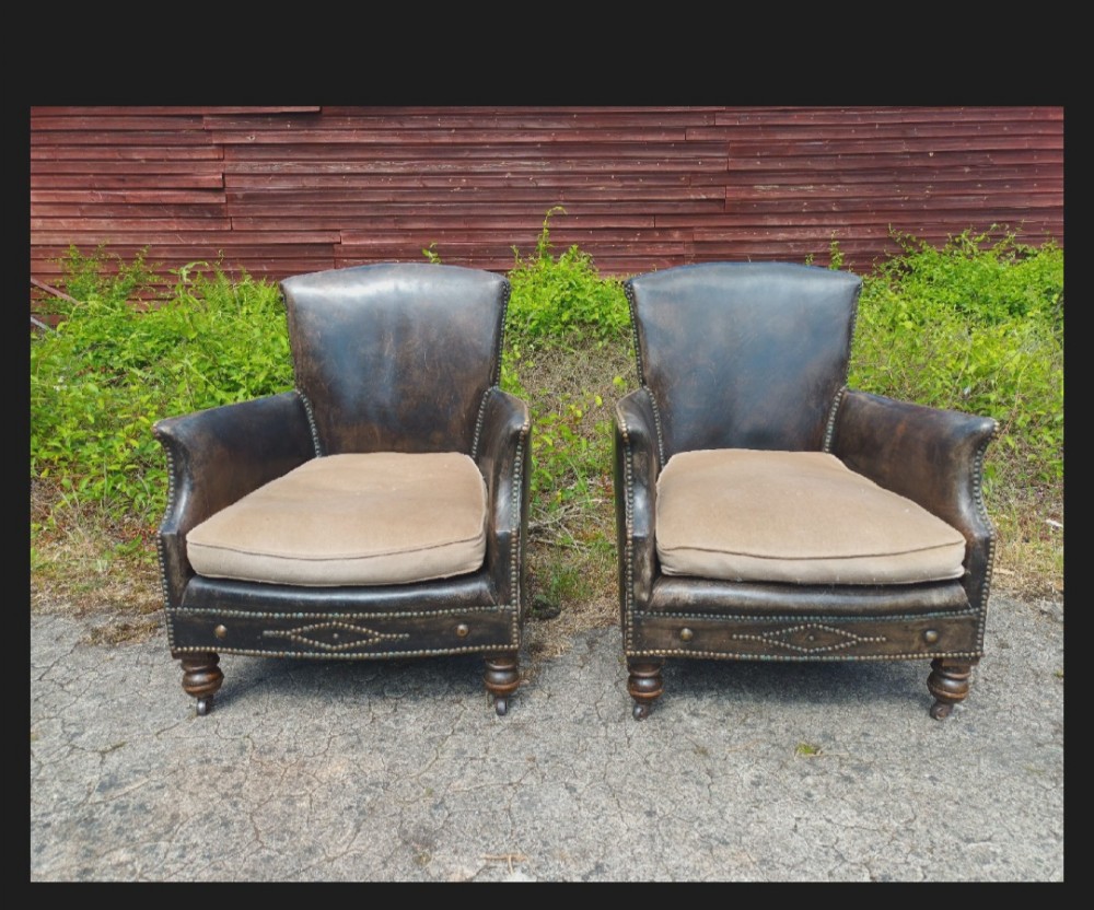 Pair of studded leather upholstered armchairs. 