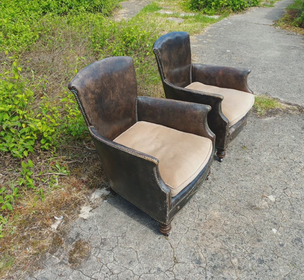 Pair of studded leather upholstered armchairs.  View V