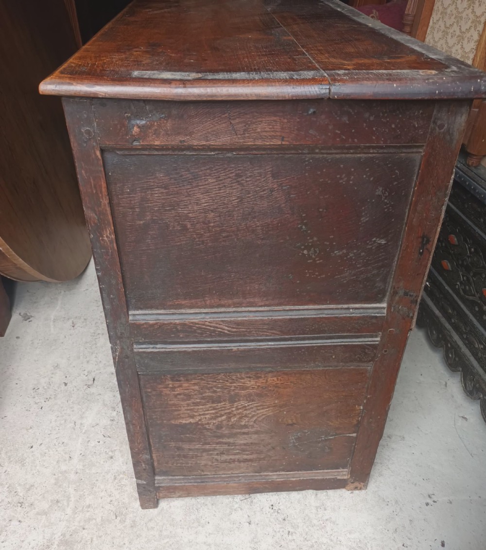 An antique two-part dark oak Welsh dresser featuring an upper plate rack with open shelves over a base cabinet with drawers and geometric panelled doors. View VIII