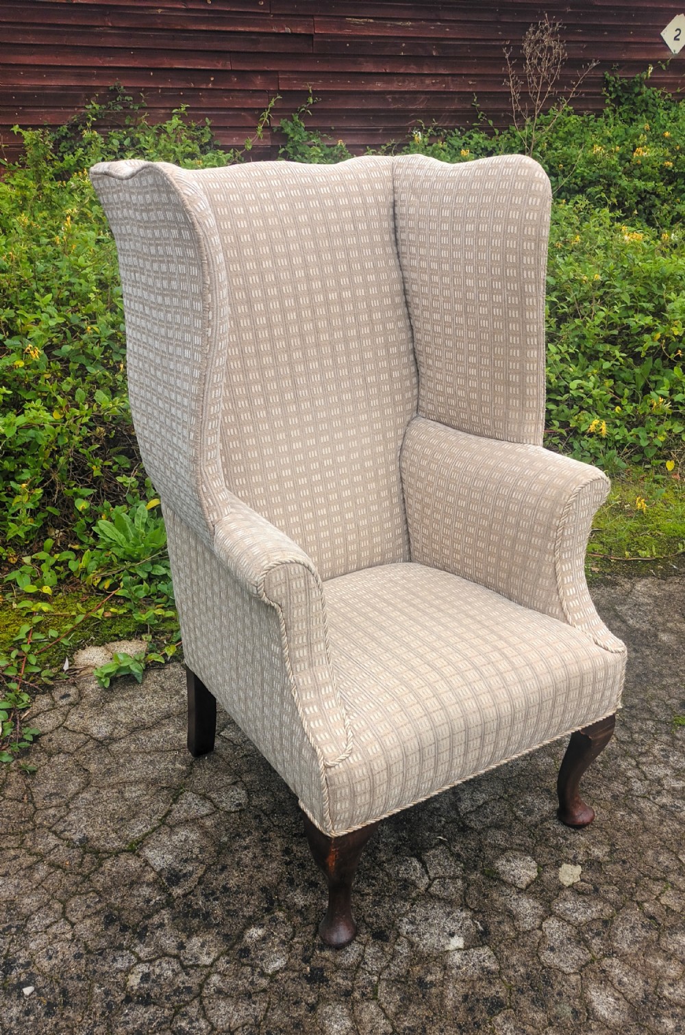 Edwardian mahogany upholstered wing back armchair. 