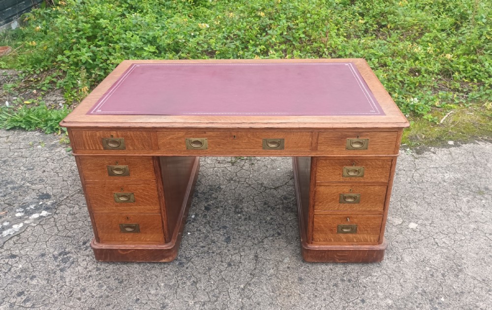 Late Victorian oak kneehole pedestal desk with campaign style handles. View III