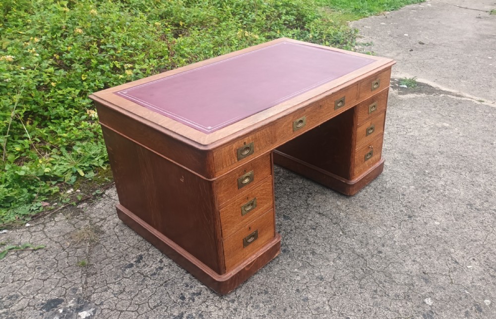 Late Victorian oak kneehole pedestal desk with campaign style handles. View V