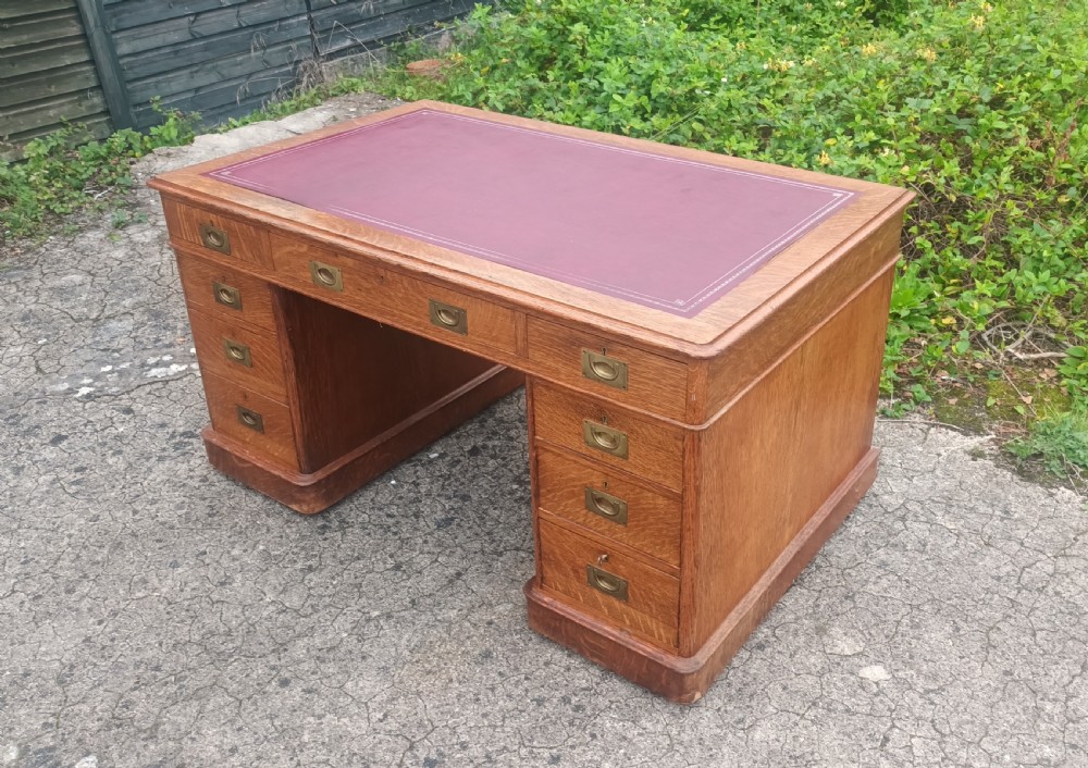 Late Victorian oak kneehole pedestal desk with campaign style handles. View VI
