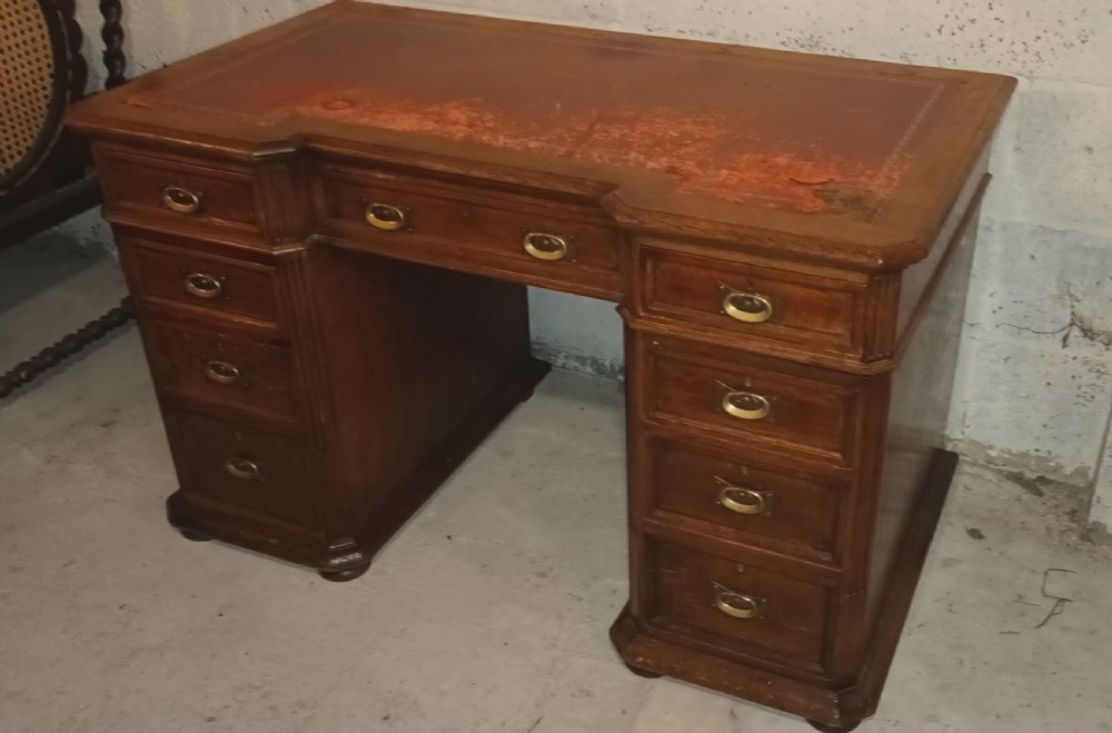 Late Victorian oak kneehole pedestal desk with side slides. View II