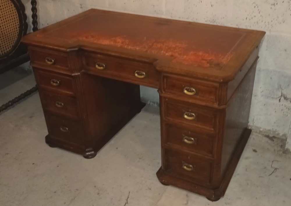 Late Victorian oak kneehole pedestal desk with side slides. View IV
