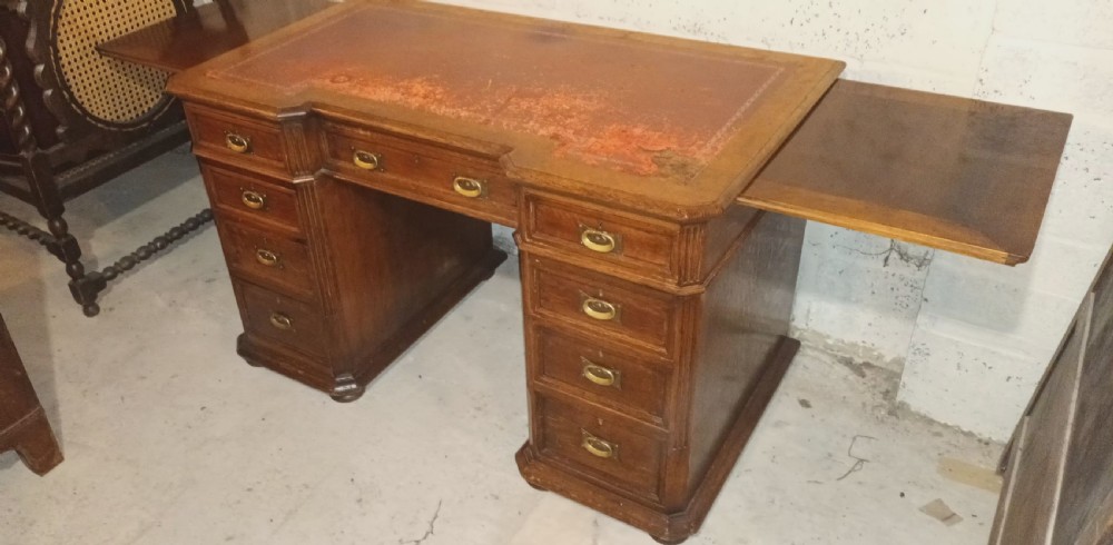 Late Victorian oak kneehole pedestal desk with side slides. View XVII