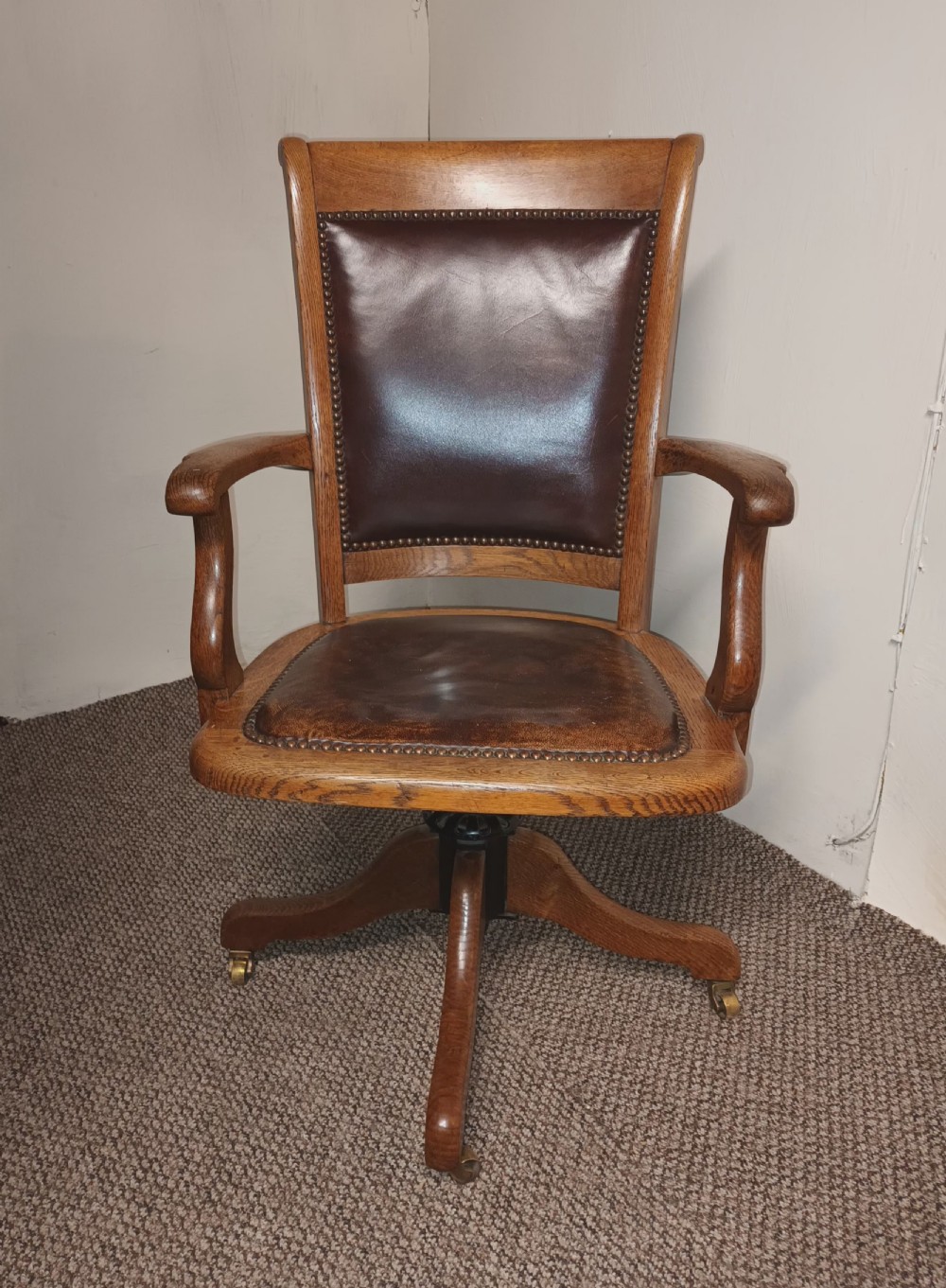 Good revolving oak and leather desk armchair. 