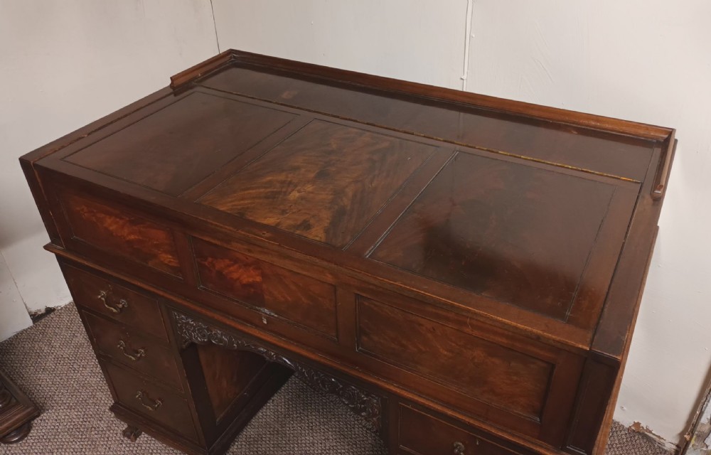 An Edwardian dark mahogany kneehole writing desk featuring a fitted upper superstructure, leather writing surface, twin drawer pedestals, brass handles, and claw feet. View III