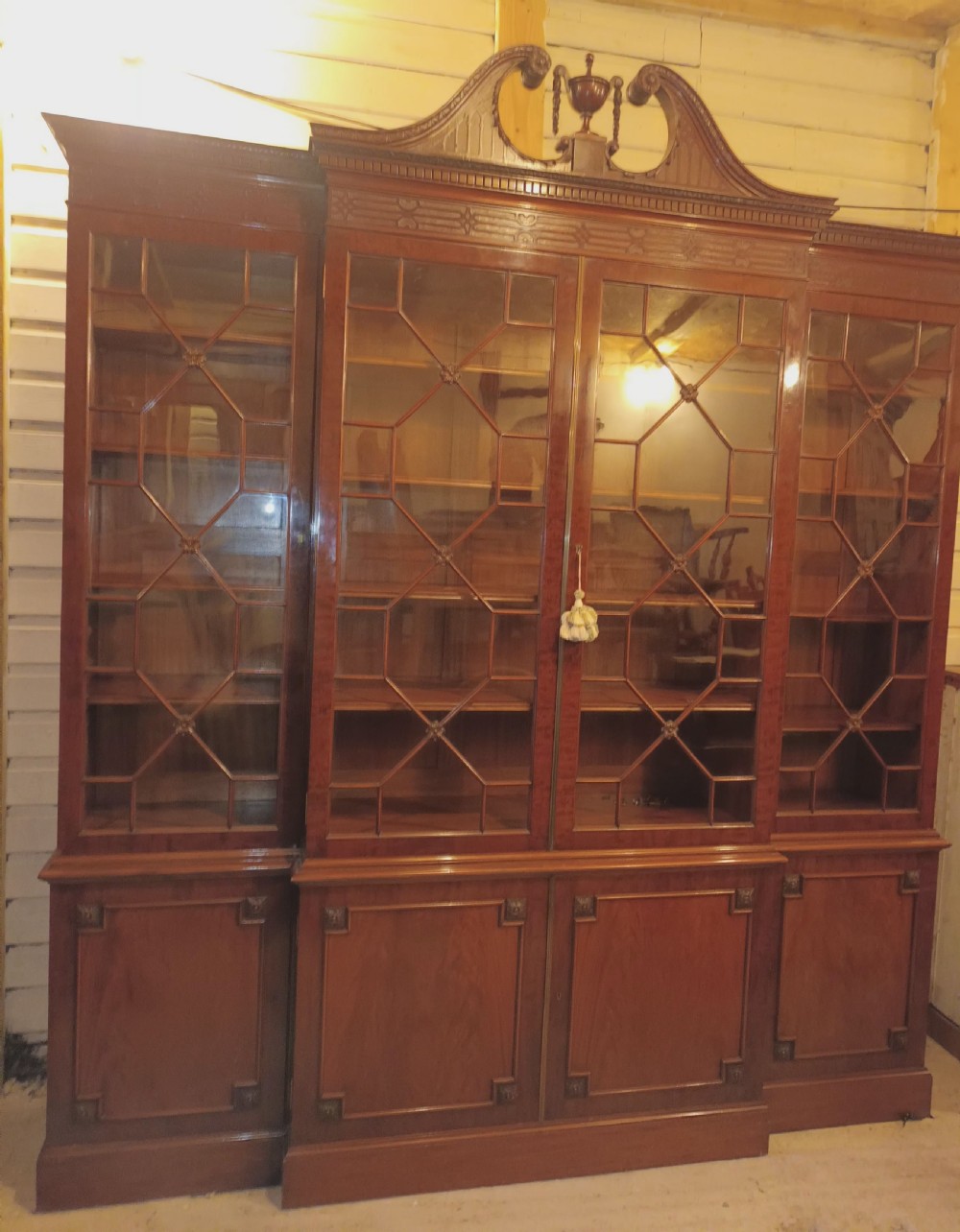 Good quality early 20th century mahogany breakfront library bookcase.  View XIX
