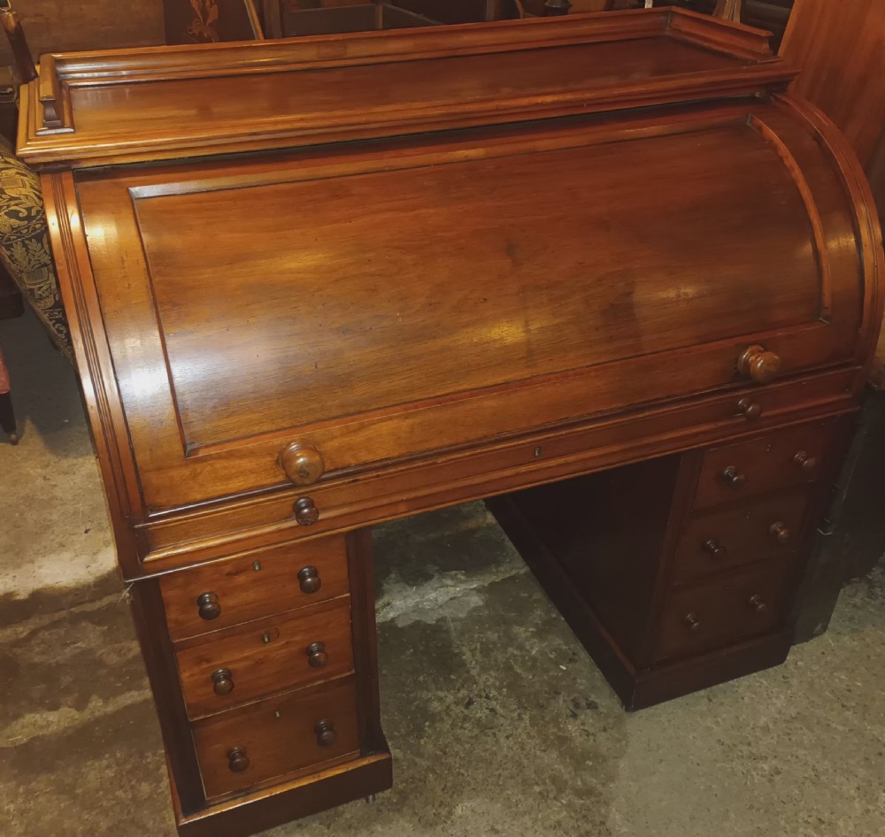 Victorian cylinder top kneehole pedestal writing desk. View II