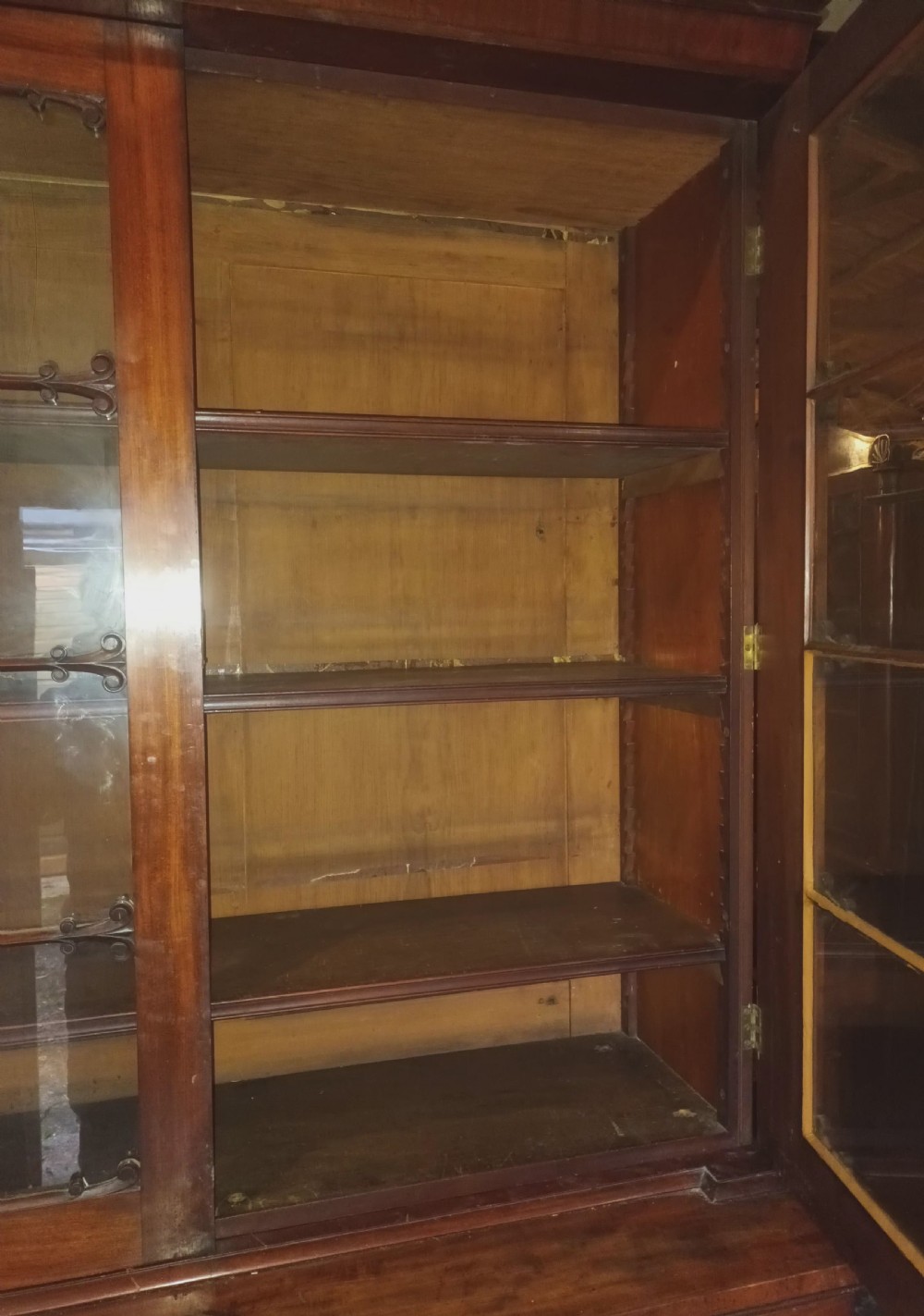A tall 19th-century mahogany library bookcase featuring two upper glazed doors over a two-door cupboard base with flame mahogany veneer panels. View VIII