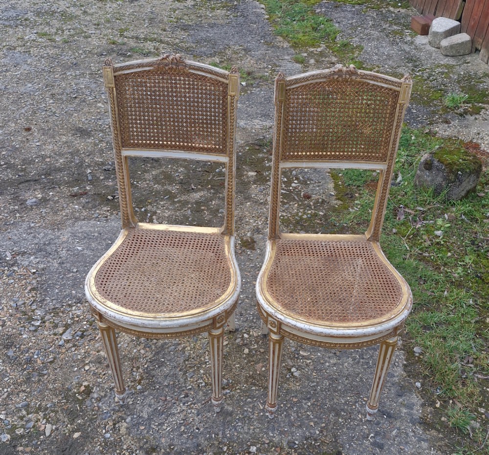 Pair of Elegant gilded decorated caned bedroom chairs from the series 