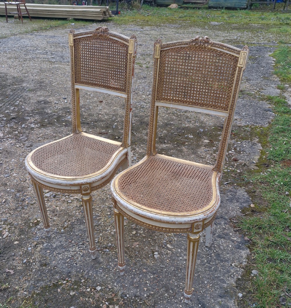 Pair of Elegant gilded decorated caned bedroom chairs from the series 