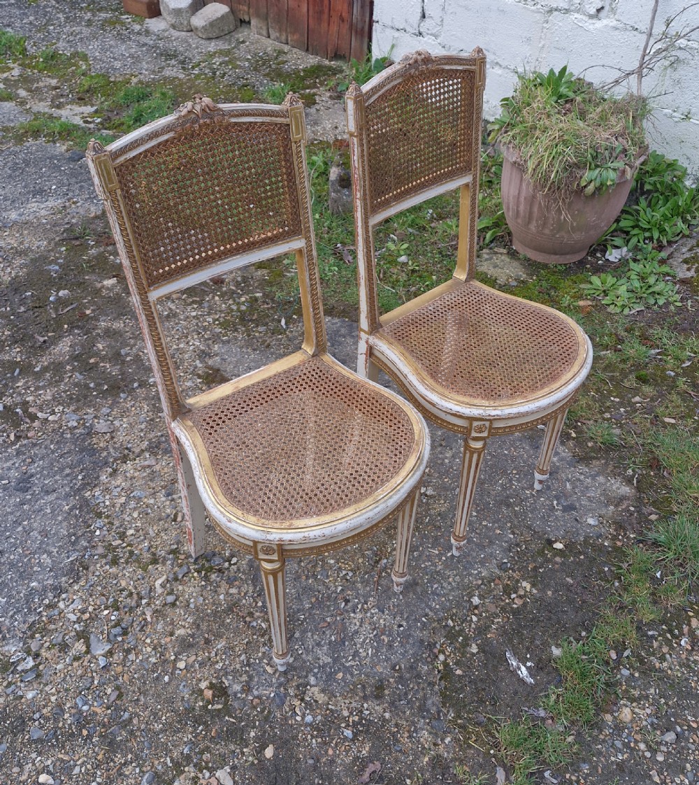 Pair of Elegant gilded decorated caned bedroom chairs from the series 
