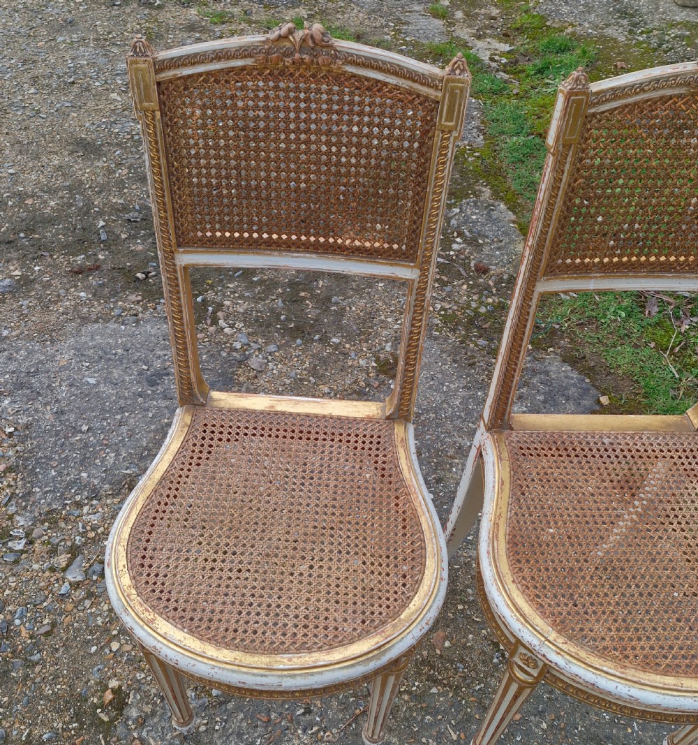 Pair of Elegant gilded decorated caned bedroom chairs from the series 
