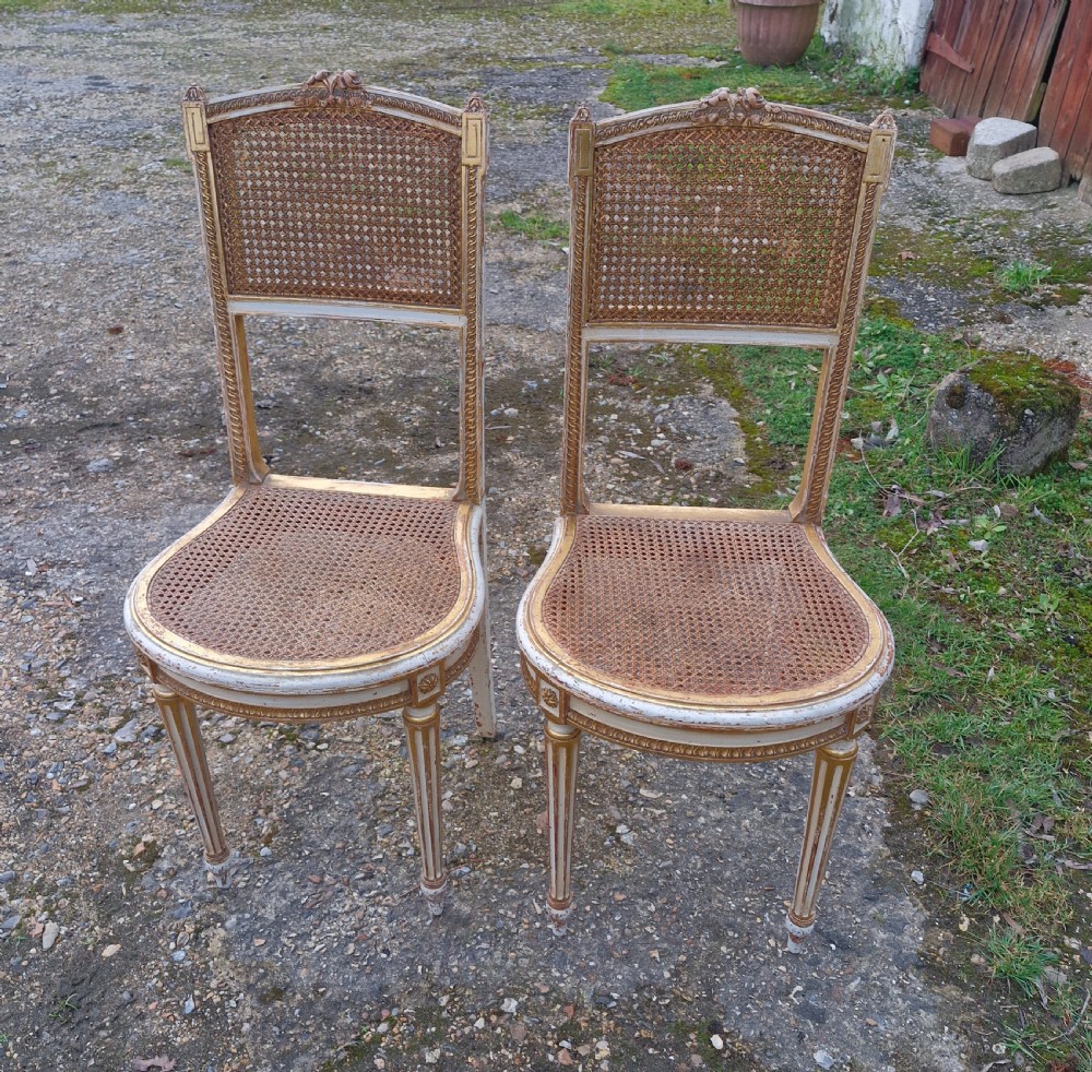 Pair of Elegant gilded decorated caned bedroom chairs from the series 