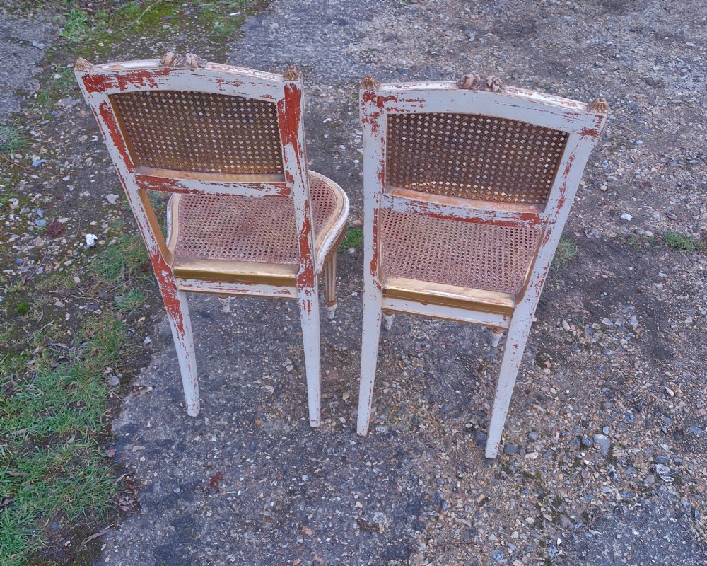 Pair of Elegant gilded decorated caned bedroom chairs from the series 