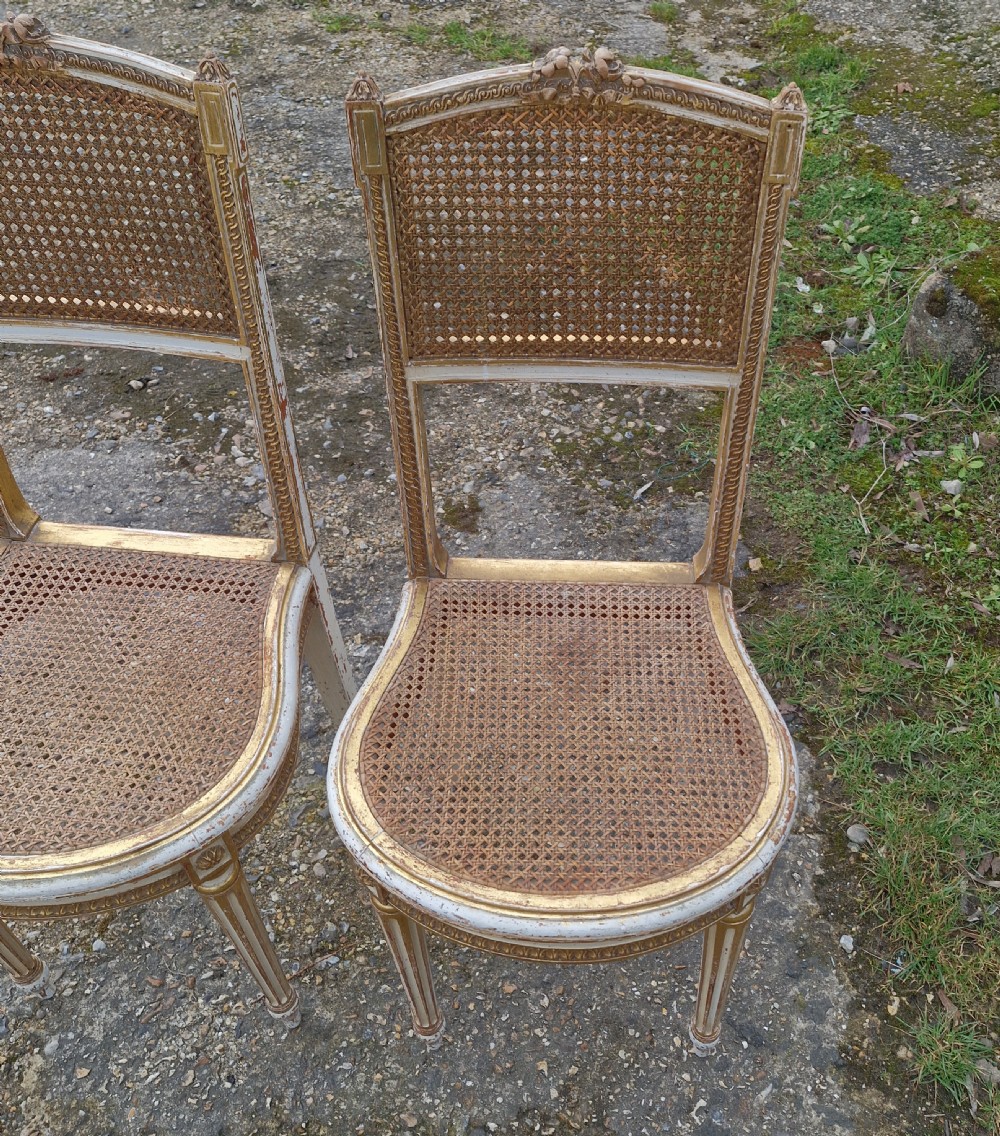 Pair of Elegant gilded decorated caned bedroom chairs from the series 