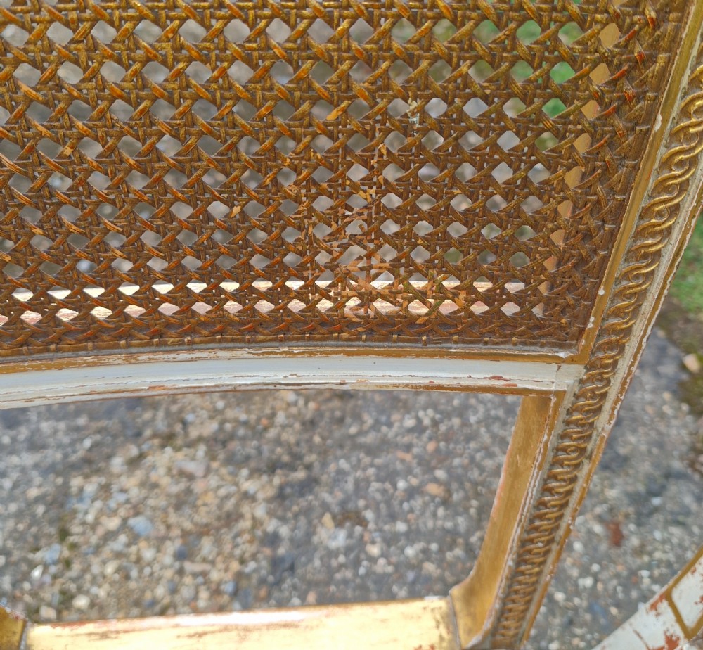 Pair of Elegant gilded decorated caned bedroom chairs from the series 