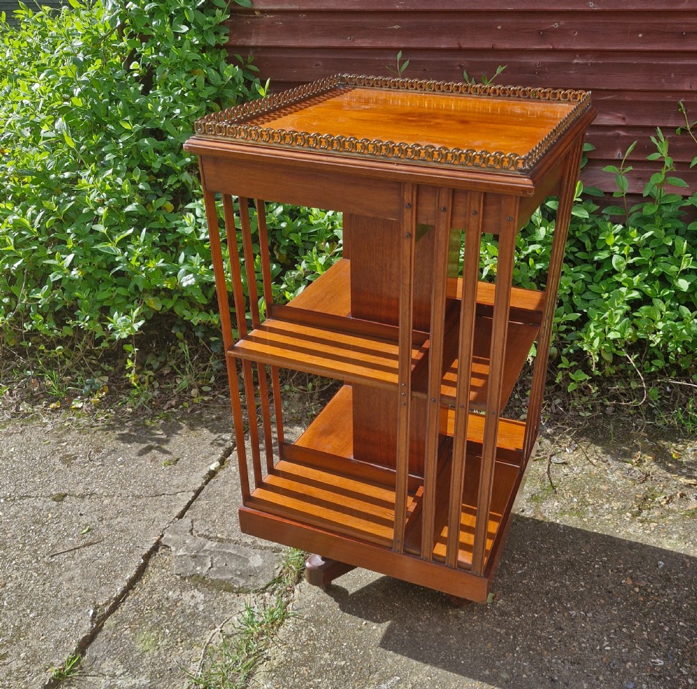 Late Victorian walnut revolving bookcase with a good gilt gallery 