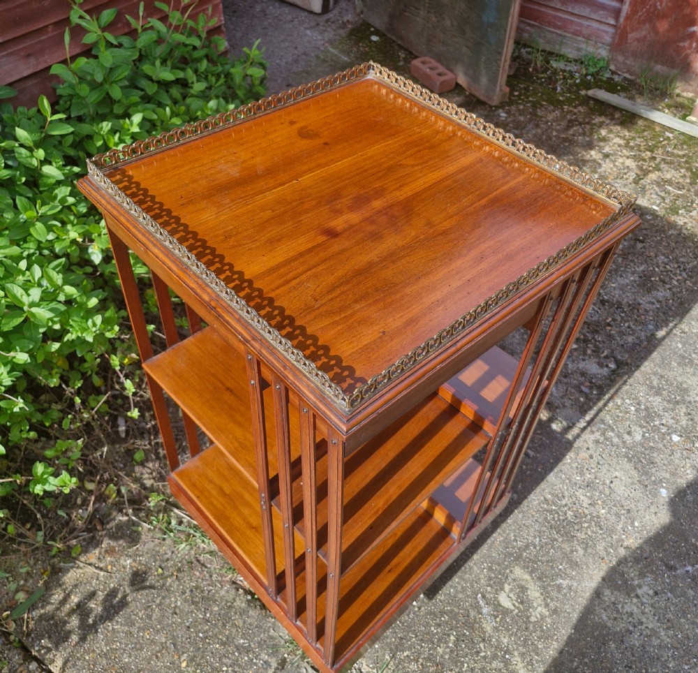 Late Victorian walnut revolving bookcase with a good gilt gallery  View II
