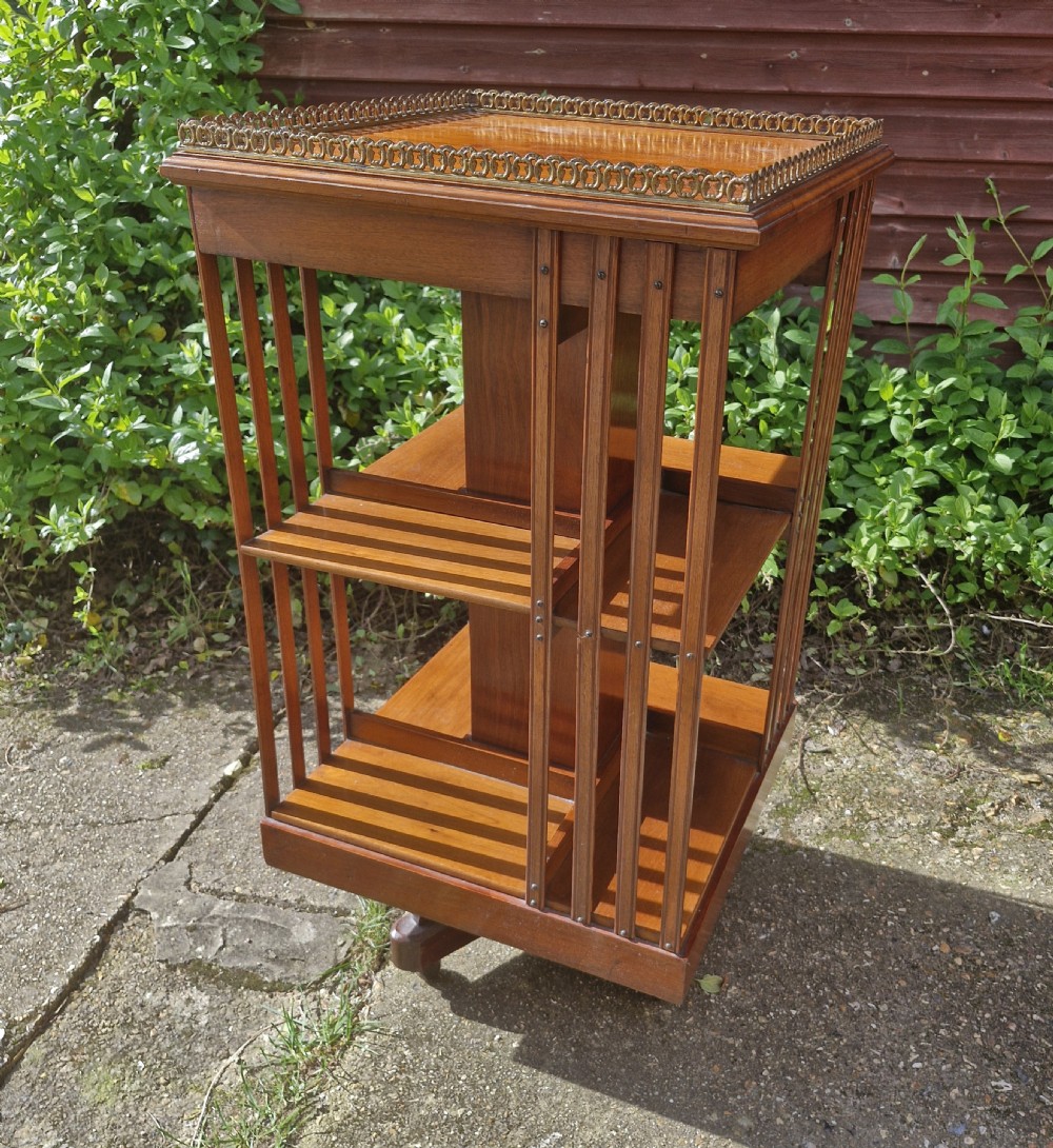 Late Victorian walnut revolving bookcase with a good gilt gallery  View III