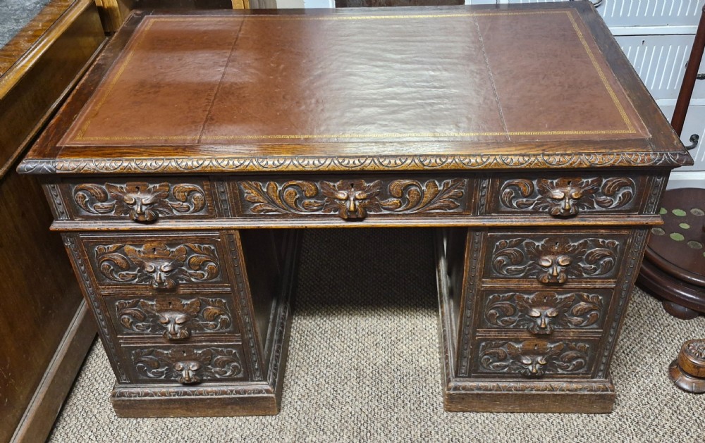Late Victorian carved oak Greenman pedestal desk.  View II
