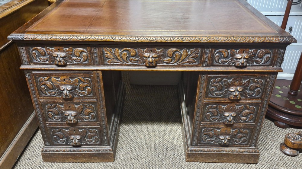 Late Victorian carved oak Greenman pedestal desk.  View IV