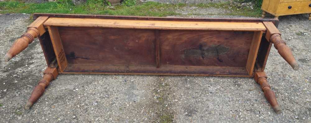 A long Victorian pine kitchen dining table featuring a single-board top with visible wood grain and four turned legs. View III
