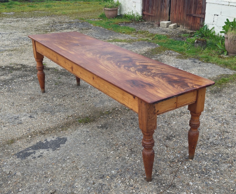 A long Victorian pine kitchen dining table featuring a single-board top with visible wood grain and four turned legs. View VIII