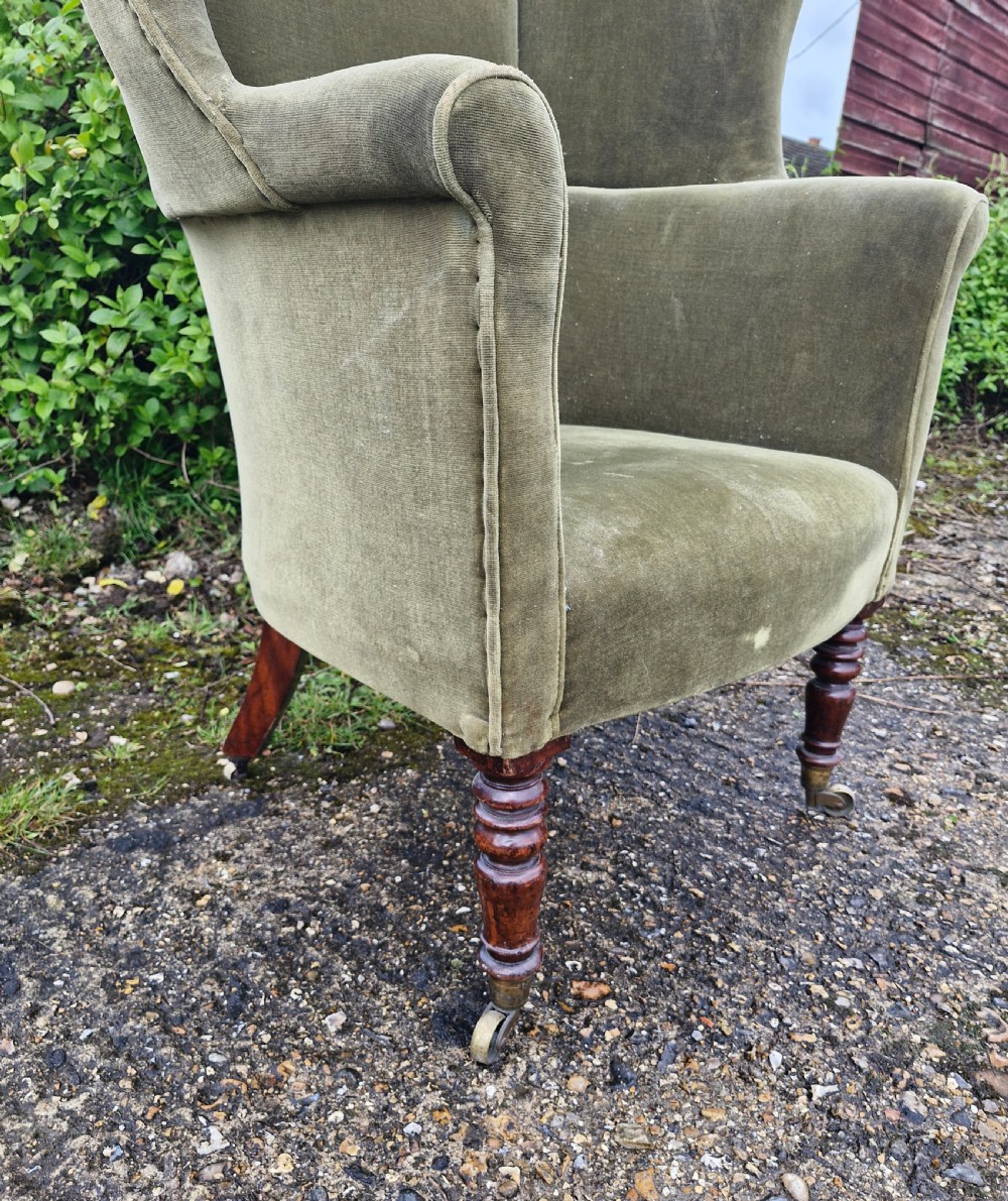 Regency mahogany upholstered wing barrel back armchair.  View II