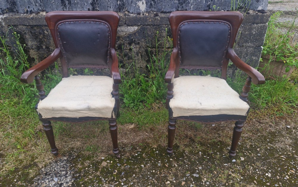 Pair of Late mahogany library desk armchairs.  View III