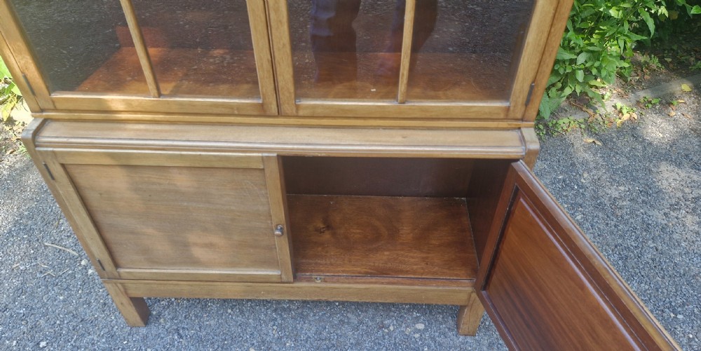 A three-tier mahogany sectional bookcase with two upper glazed double doors and a solid wooden cupboard base. View II