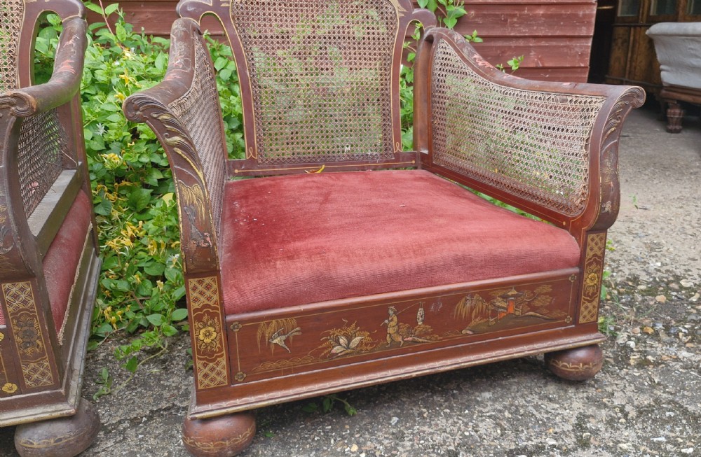A set of three low-built chinoiserie bergere armchairs featuring hand-painted lacquered frames, woven cane backs and sides, and red velvet seats. View IX