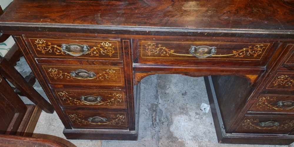 A late Victorian dark rosewood dressing table featuring classical bone and satinwood marquetry, a central swing mirror, raised trinket drawers, and twin pedestal storage. View VI