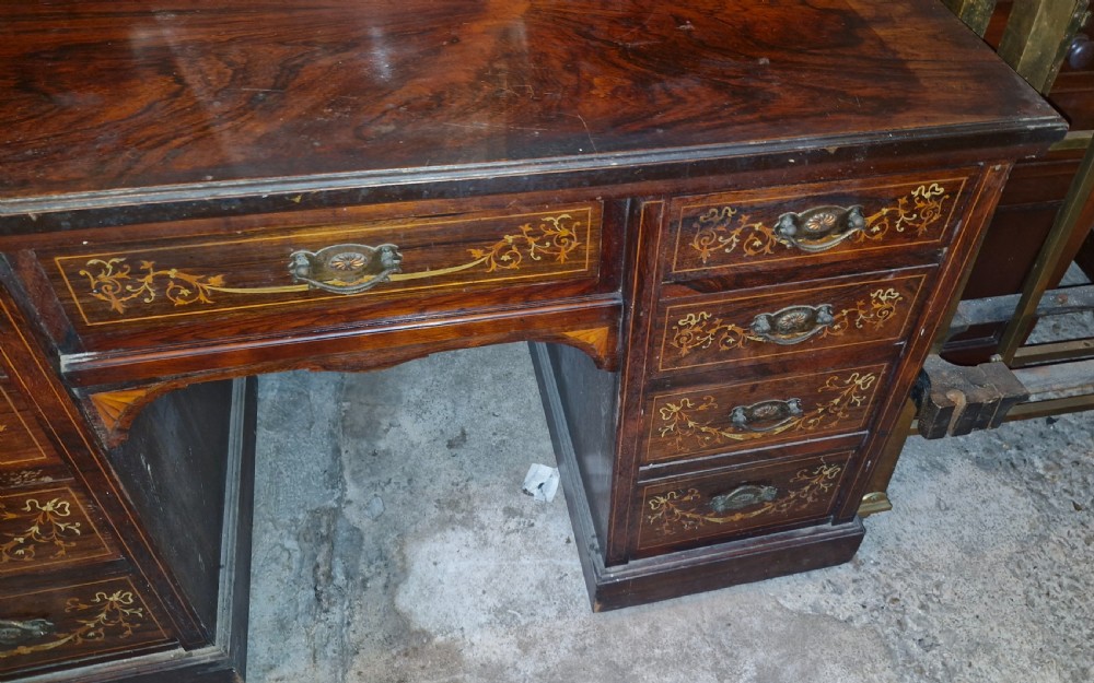 A late Victorian dark rosewood dressing table featuring classical bone and satinwood marquetry, a central swing mirror, raised trinket drawers, and twin pedestal storage. View VII