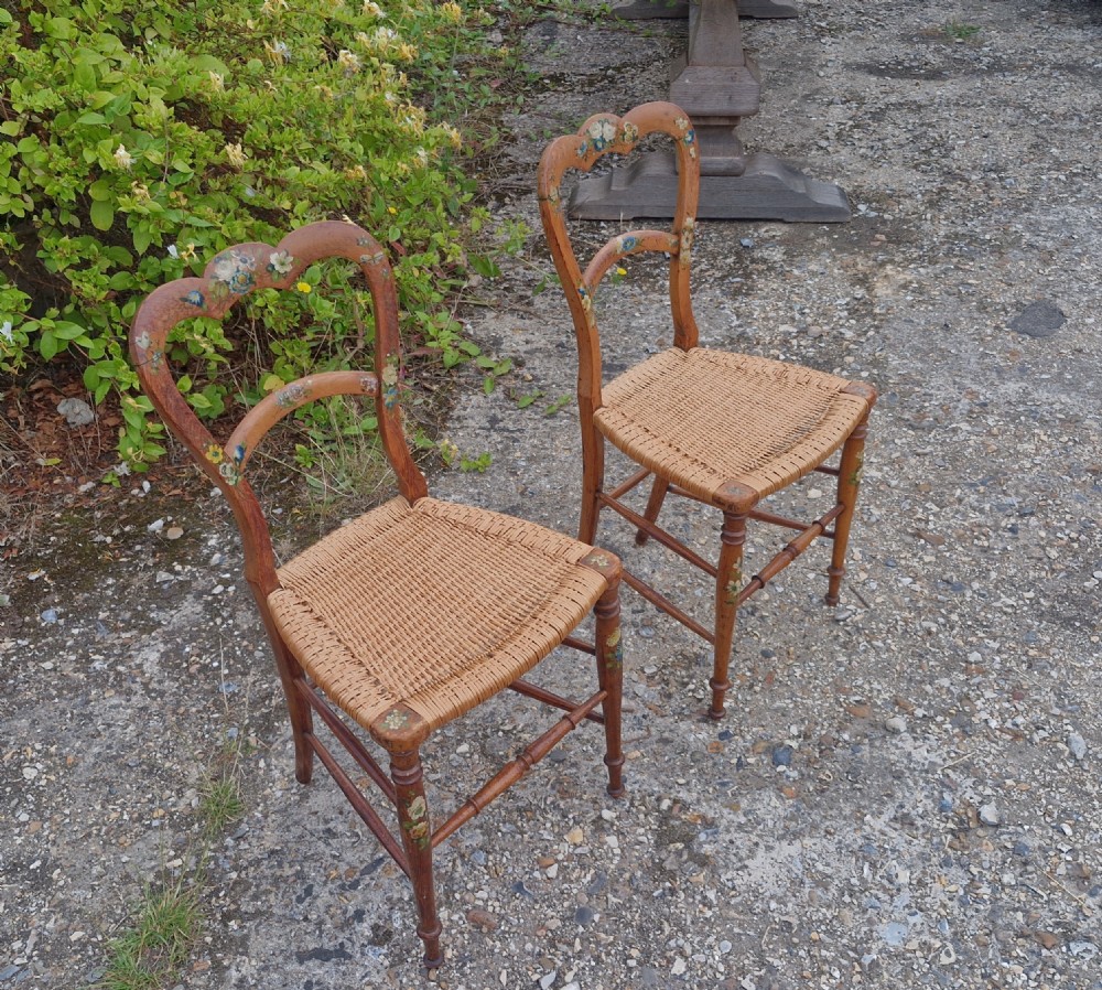 A pair of Victorian side chairs featuring light brown wooden frames adorned with hand-painted floral motifs and woven cane seats. View XI