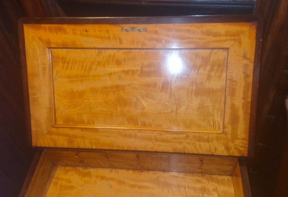 A Regency rosewood Davenport desk featuring a sloped leather writing surface, gallery top, spiral support columns, and side drawers. View V