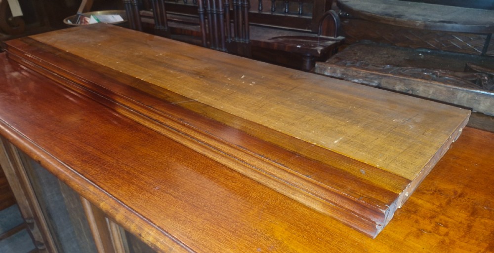 A large late Victorian mahogany low bookcase featuring four glazed glass doors with removable timber shelves resting in front. View II